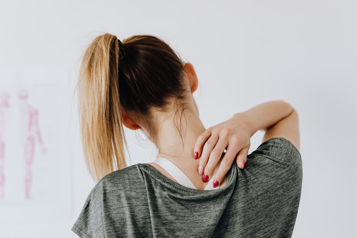Person with neck pain — chiropractor and pain practice marketing Louisville KY