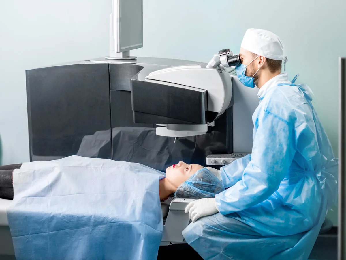 Eye surgeon performing laser vision-correction surgery on a patient