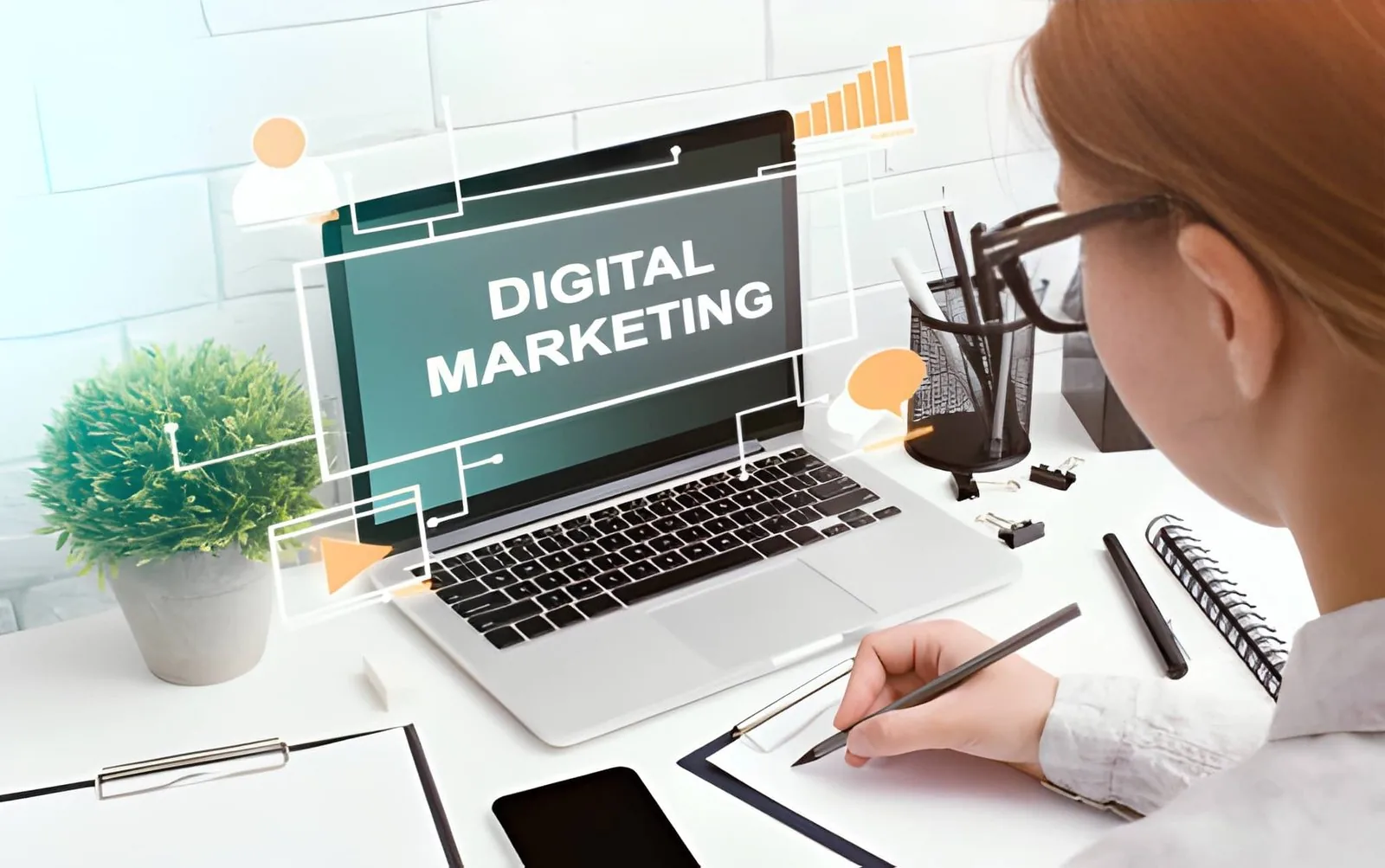 A person working on a laptop with a digital marketing graphic overlay