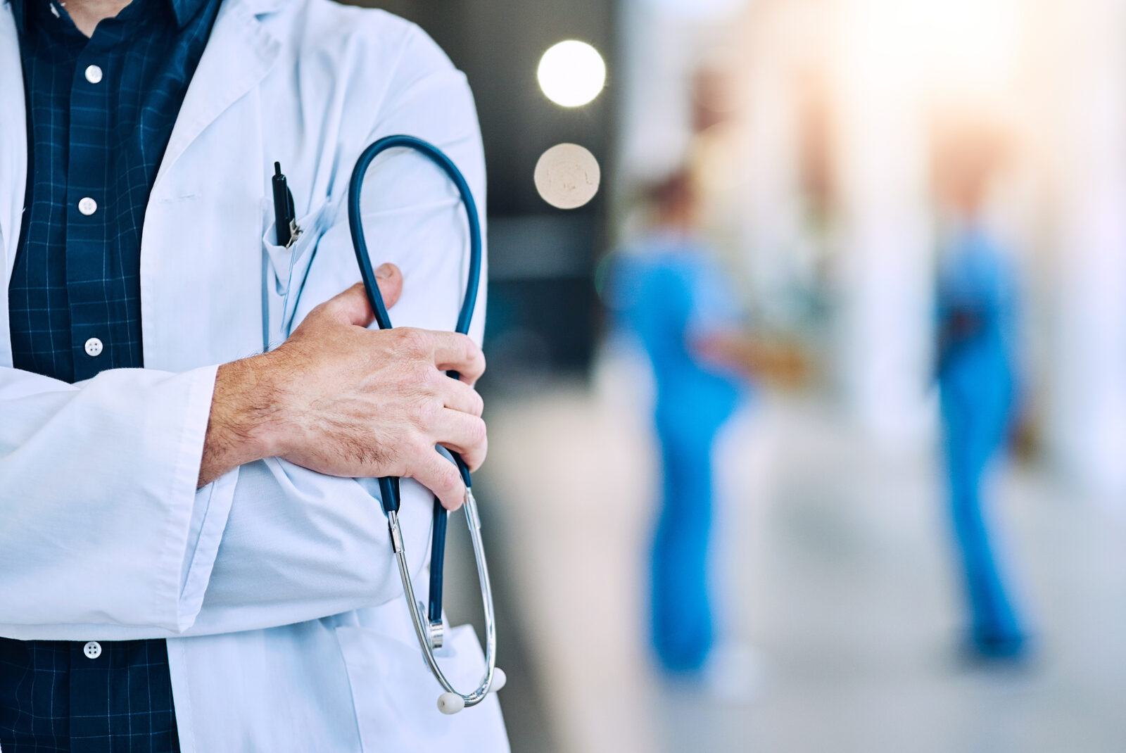Physician with stethoscope inside a modern healthcare facility