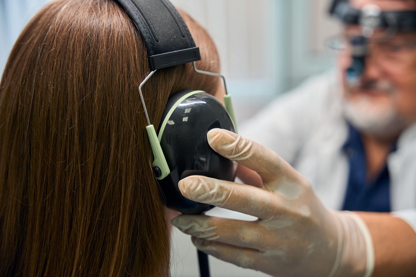 Audiologist examining a patient hearing test in a clinical setting