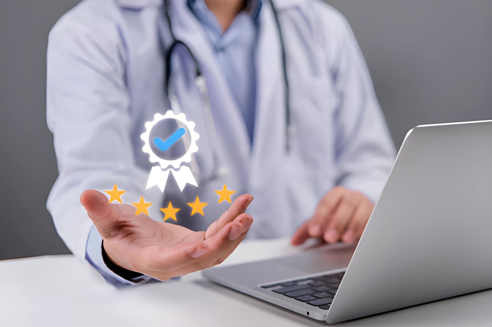 A doctor in a white coat using a laptop, with a digital icon of a badge with a checkmark and five stars floating above their hand.