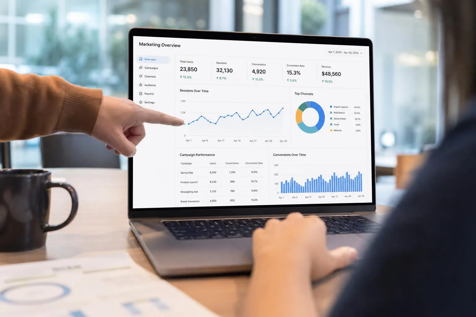 Open notebook with handwritten notes next to analytics printouts