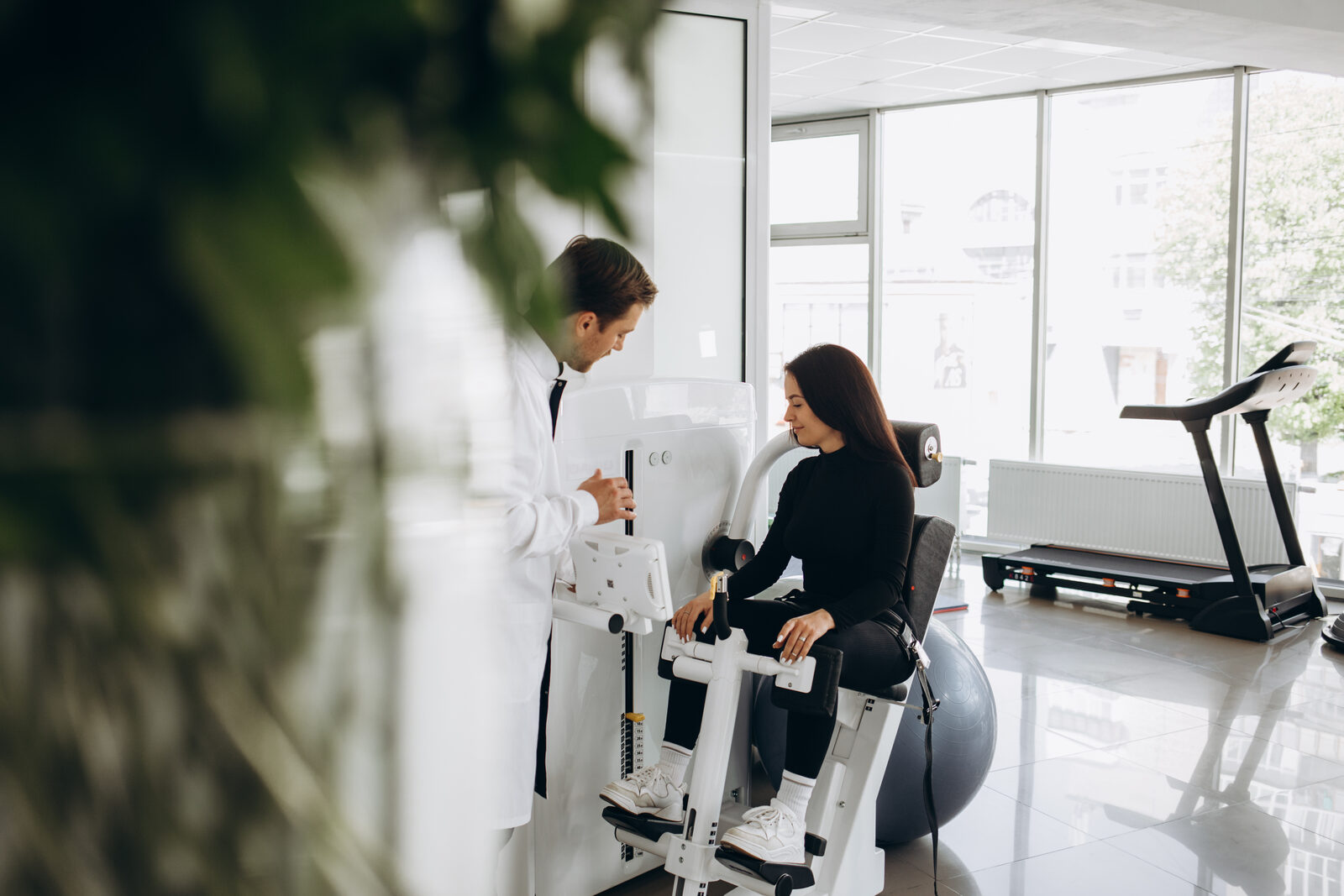 Patient working on a rehabilitation exercise machine during physical therapy